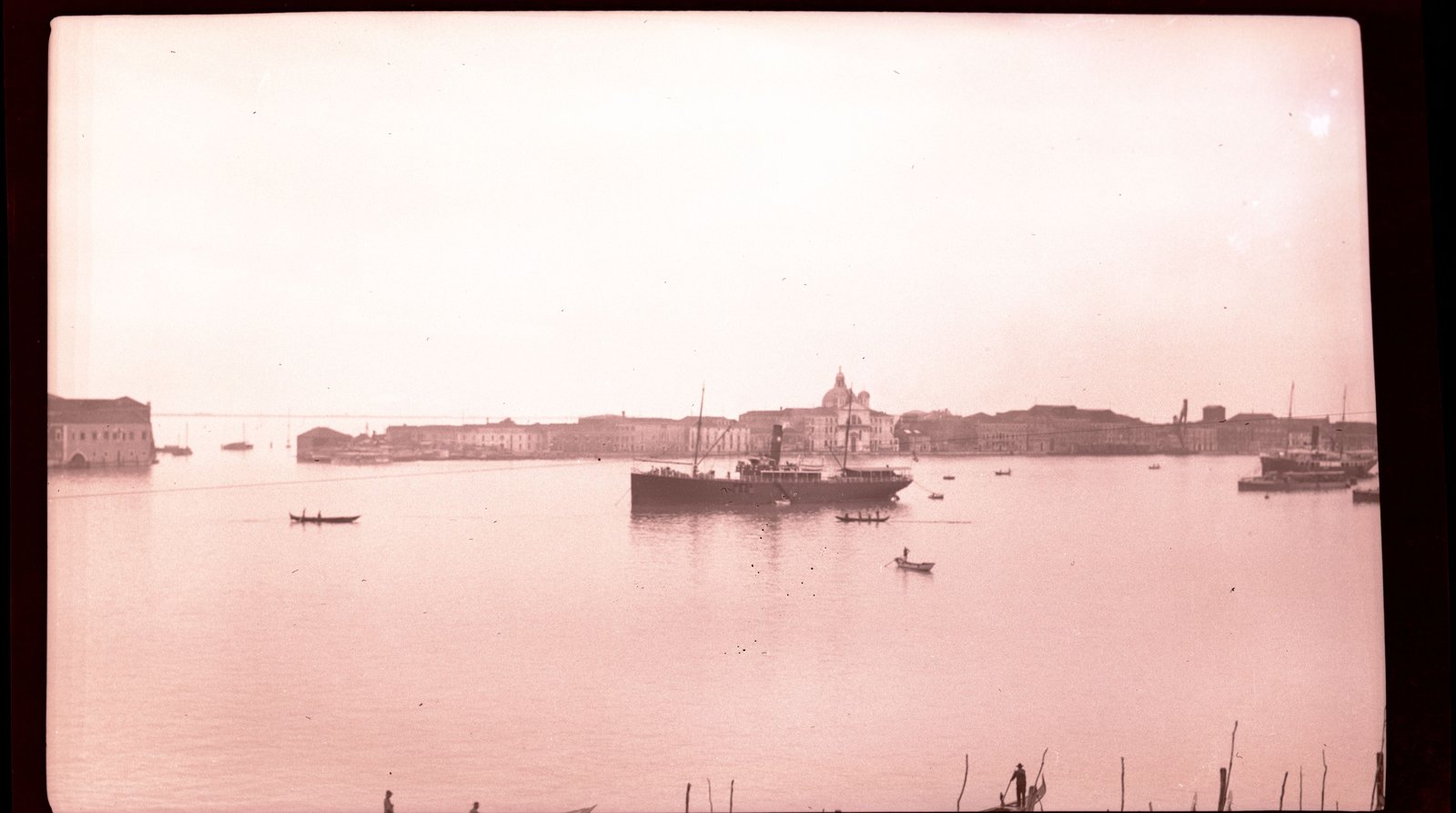 Boats moving across open water in the Venetian lagoon.