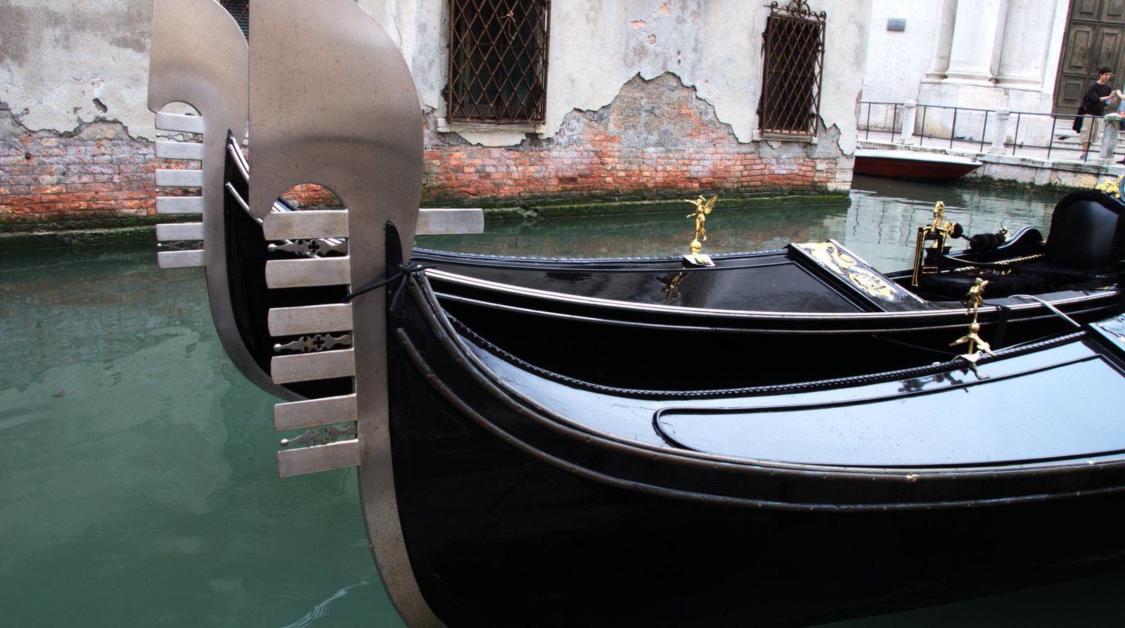 A traditional Venetian rowing boat moving along a canal.