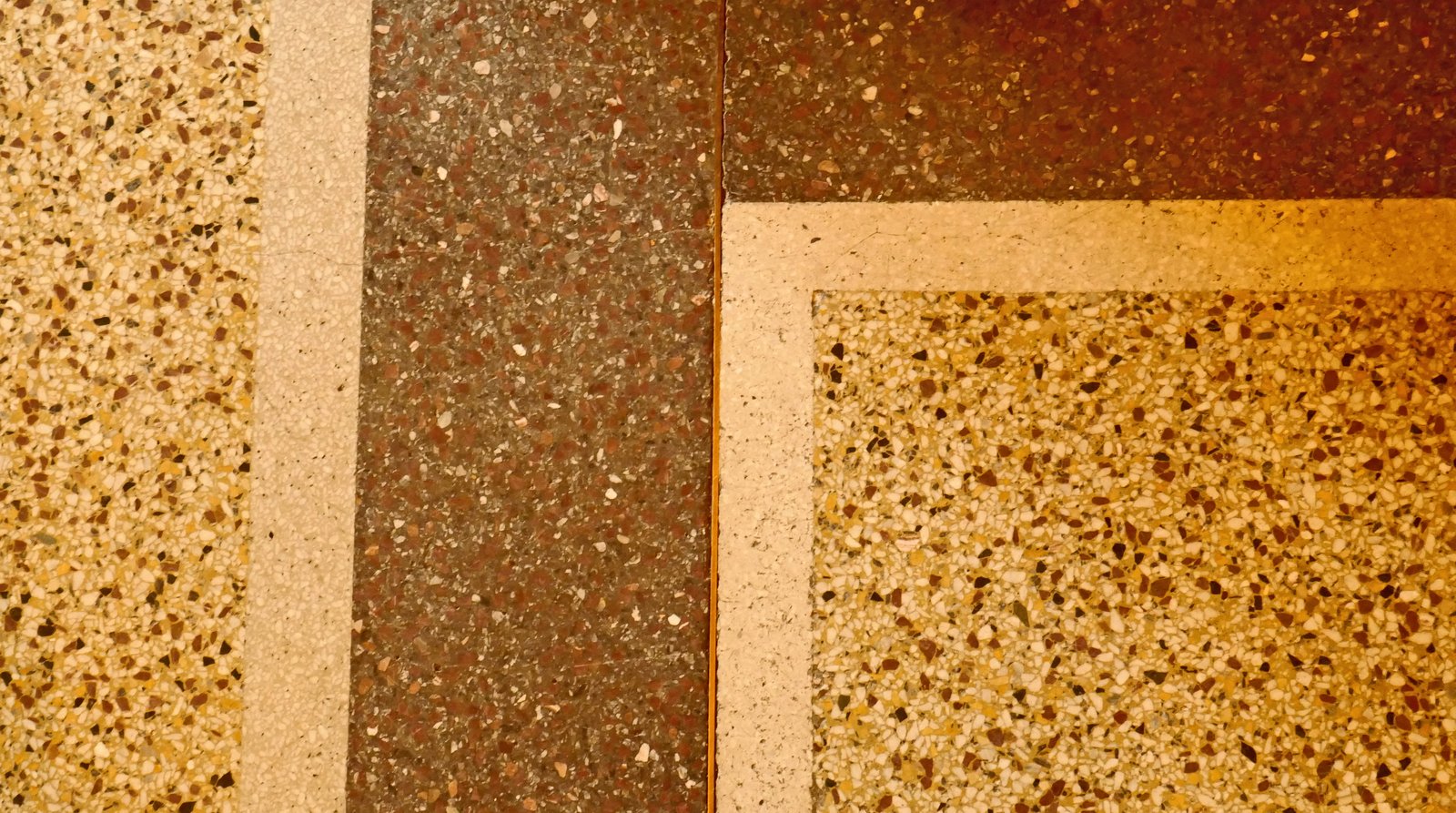 A close view of a polished terrazzo floor with embedded stone fragments.