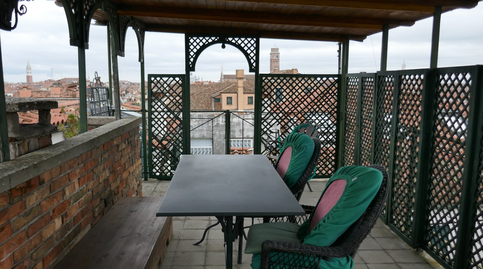 A wooden rooftop altana terrace above the rooftops of Venice.