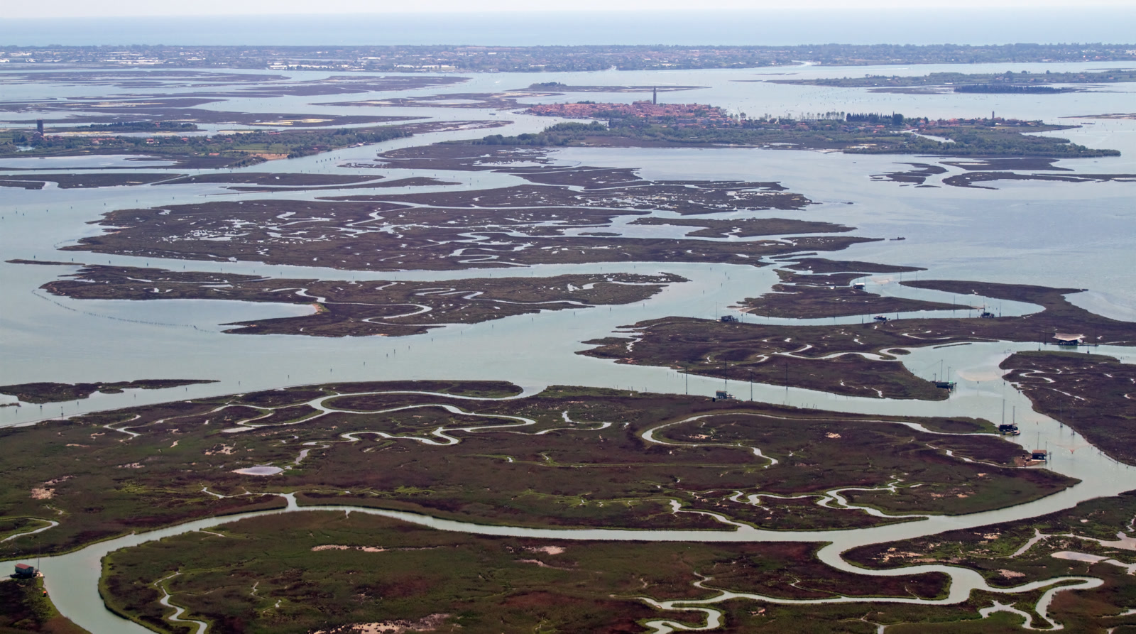 Aerial view of channels, salt marshes and shallow water in the northern Venetian Lagoon.