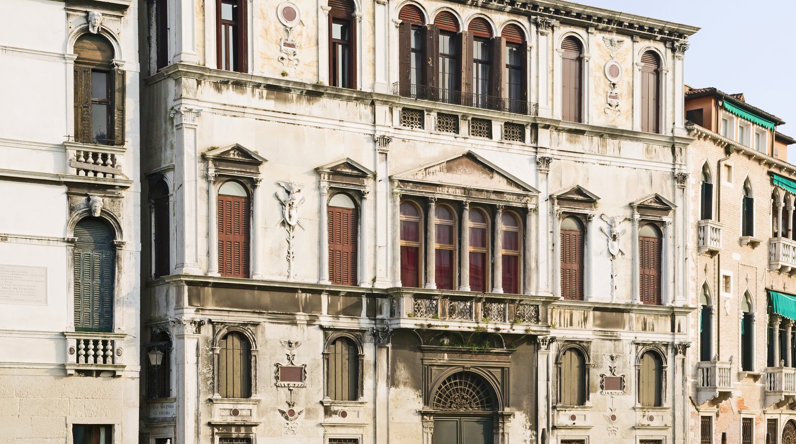 A Grand Canal palazzo facade reflected in the water.