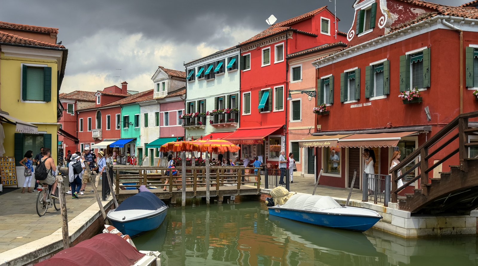Brightly painted houses lining a quiet canal on the island of Burano.