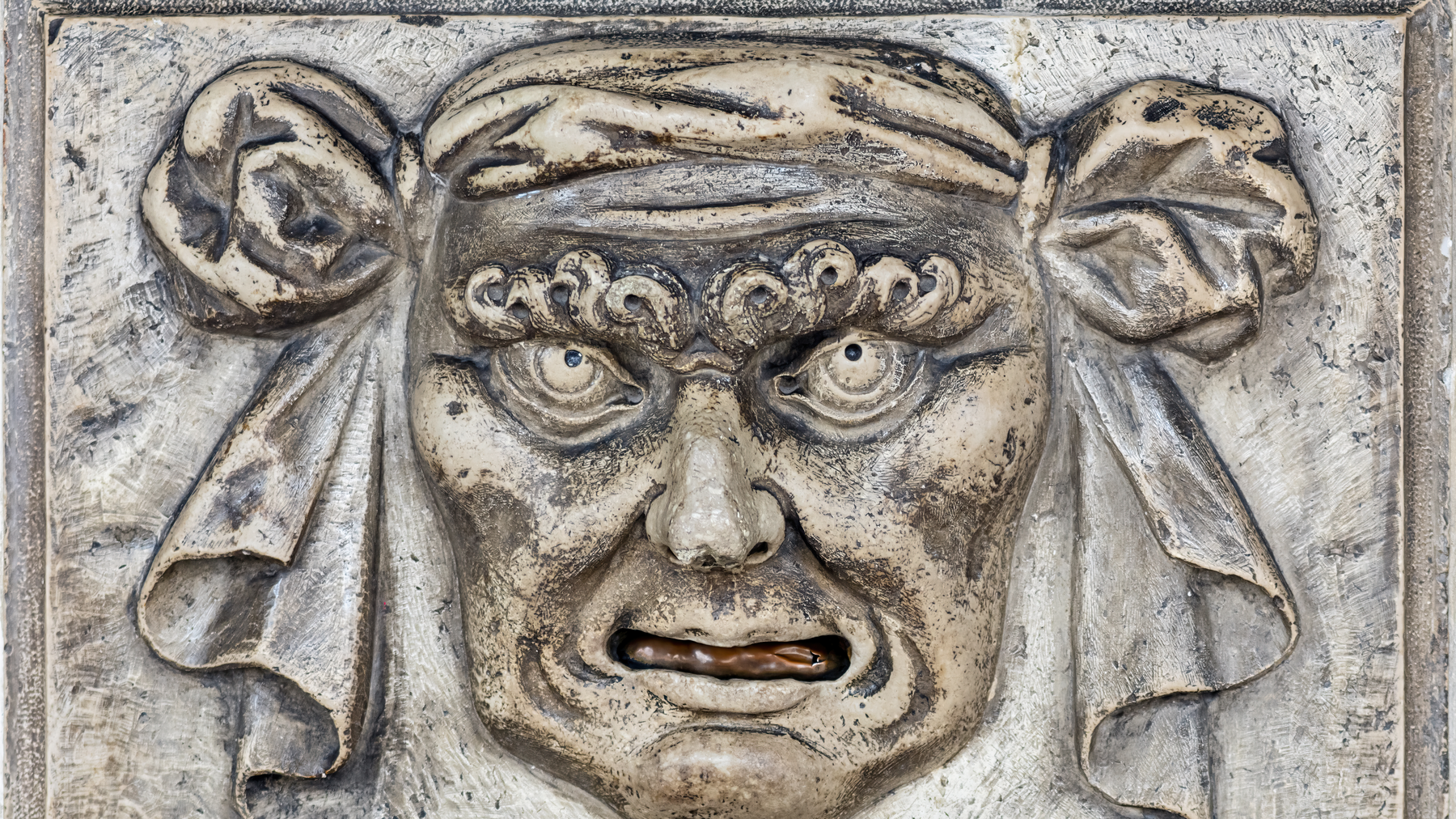 Editorial illustration of a weathered stone wall with a carved denunciation slot, evoking Venice's bocca di leone letterboxes.