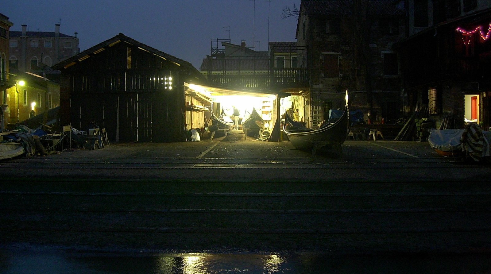 The wooden boatyard of Squero San Trovaso, lit at night.