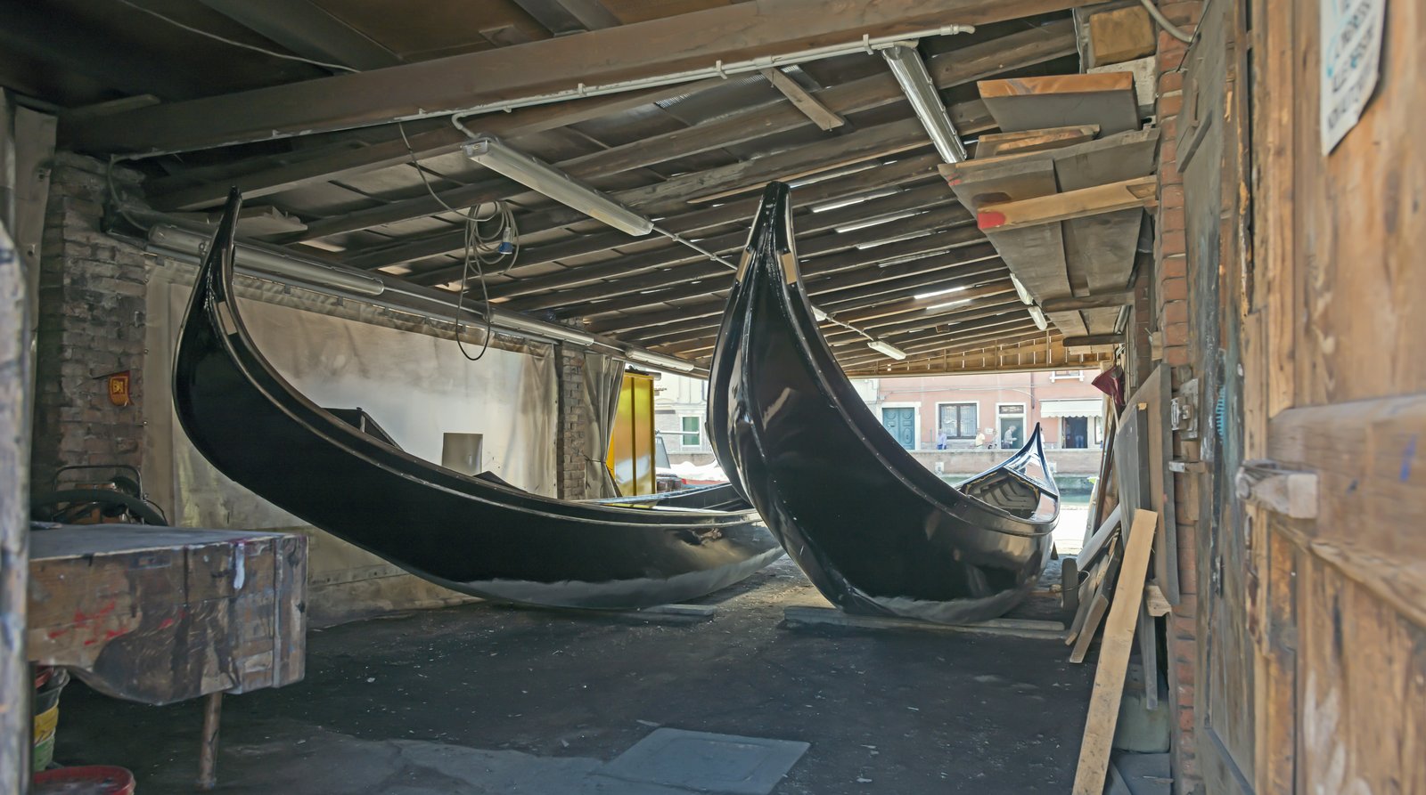 The interior of a squero boatyard with a gondola under construction.