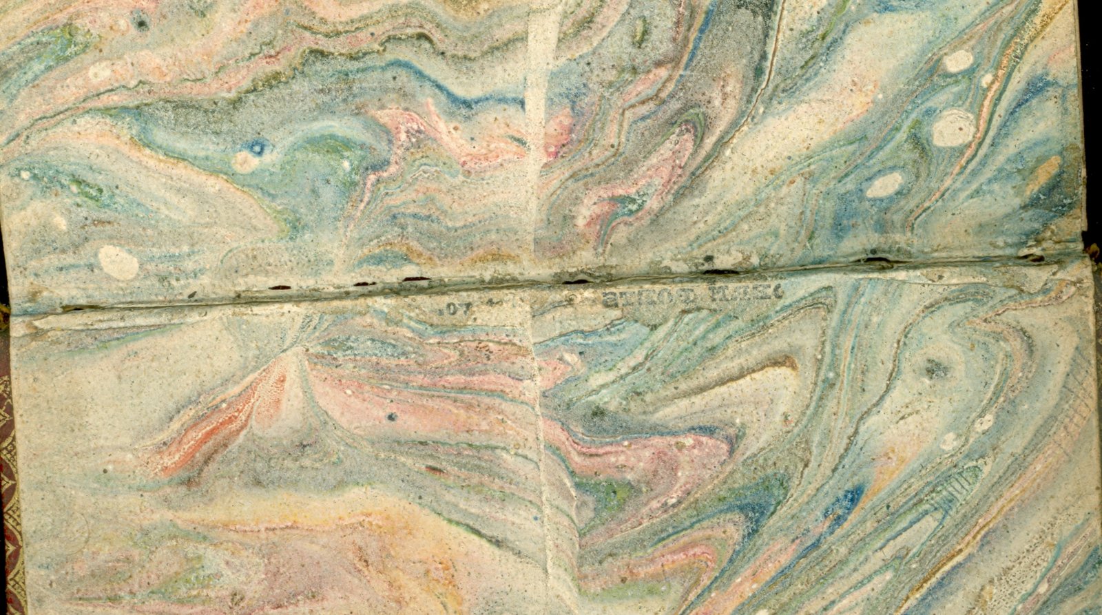Marbled endpapers inside a historic hand-bound book.